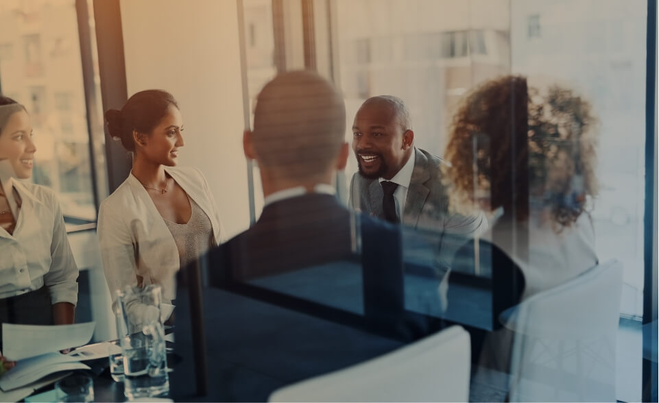 people conversing in a conference room